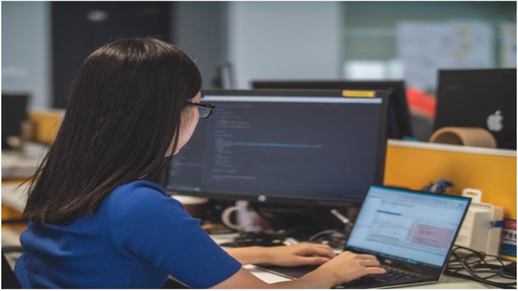 A woman in an office researching PSA software systems during a meeting